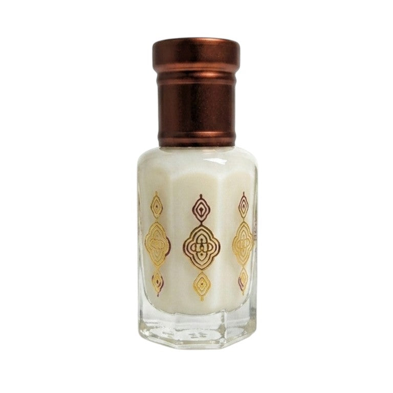Nifique Musk Tahara white musk oil in a hexagonal glass bottle with gold ornate patterns and a bronze cap.