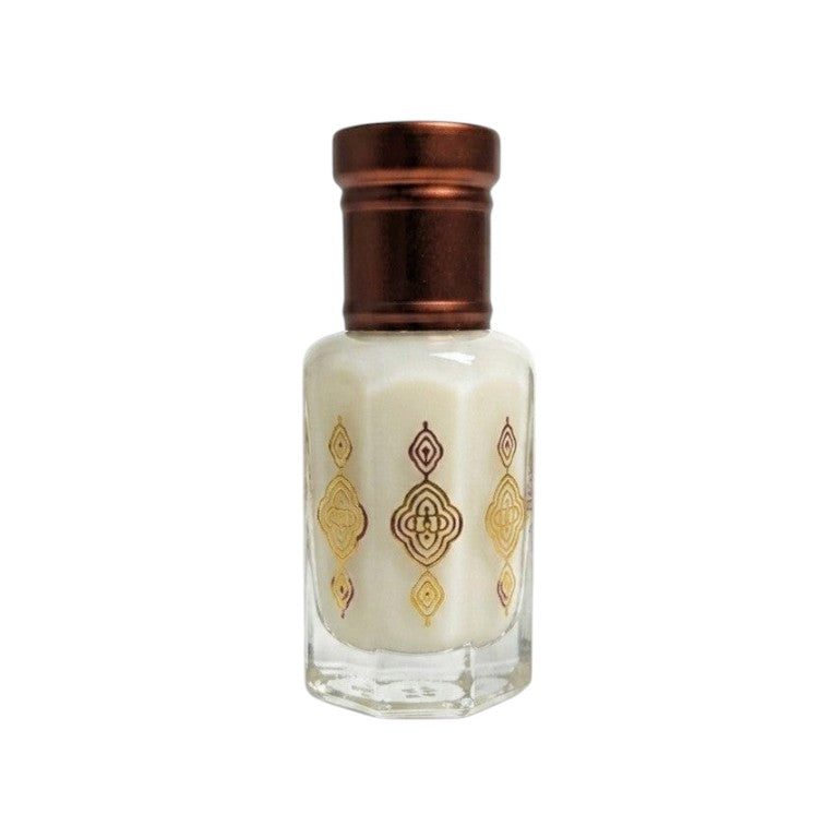 Nifique Musk Tahara white musk oil in a hexagonal glass bottle with gold ornate patterns and a bronze cap.
