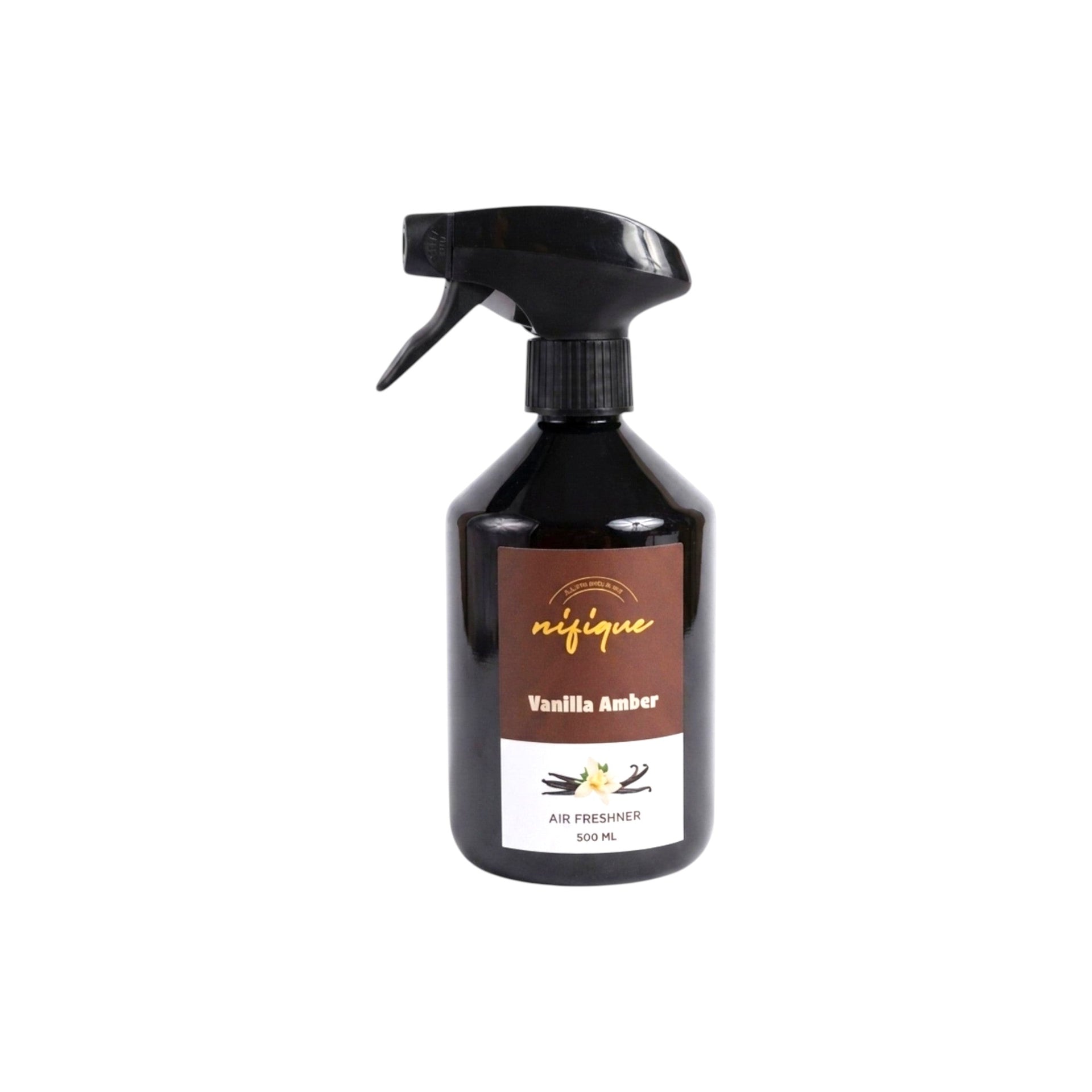 A 500 ml trigger spray bottle of Nifique Vanilla Amber air freshener. The bottle is dark amber glass with a black spray nozzle and a label featuring a brown top section and a white bottom section with vanilla bean illustrations.
